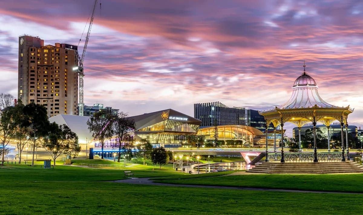 Adelaide's Elder Park and riverside buildings at dusk.