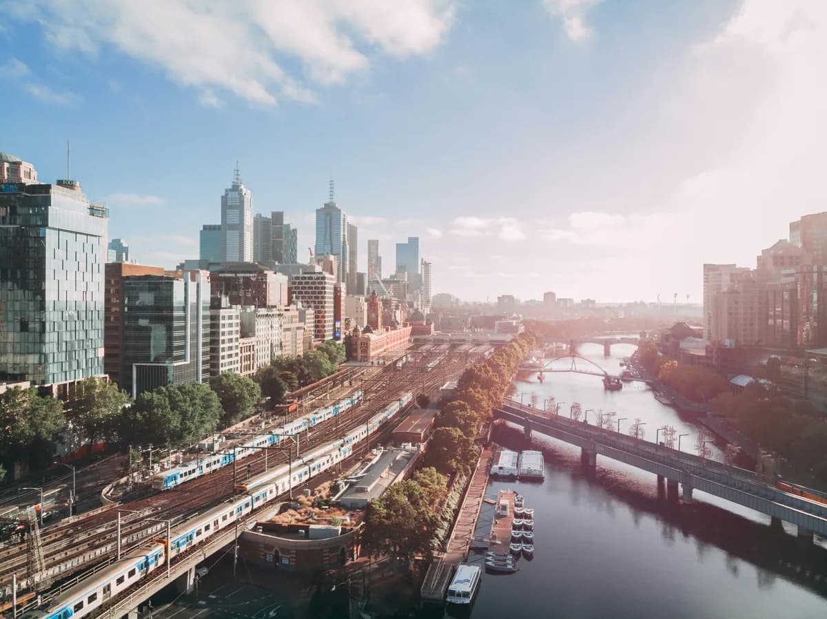 Melbourne's skyline beside the Yarra River and railway lines.