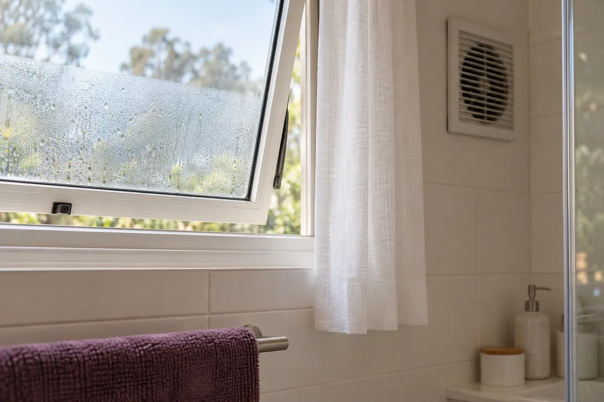 Condensation on a partly open bathroom window.